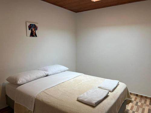 a bedroom with a bed with two towels on it at Urban Apartment 2 Bed 1 Bath in Baños