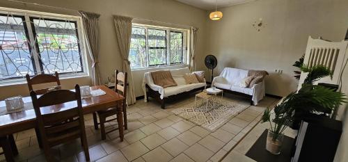 a living room with a couch and a table at Authentic Suriname in Paramaribo