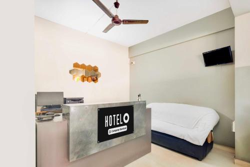 a hotel room with a bed and a television at Hotel O Kakinada near JNTU in Kākināda