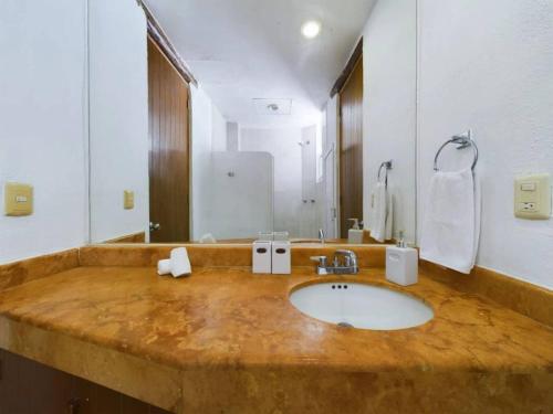 a bathroom with a sink and a large mirror at Stylish 1BR Apartment with Private Terrace in Playa del Carmen in Playa del Carmen