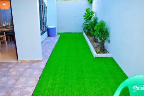 a green artificial grass floor in a room at Casa Bayaguana in Bayaguana