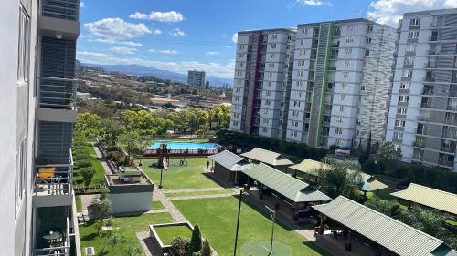 a view of a park with a pool and buildings at Apartamento en Ecovivienda Tegucigalpa in Tegucigalpa
