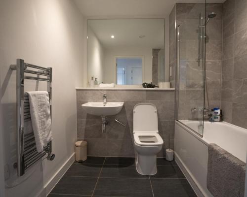 a bathroom with a toilet and a sink and a shower at Luxury 2 Bed Penthouse Manchester Large Balcony in Manchester