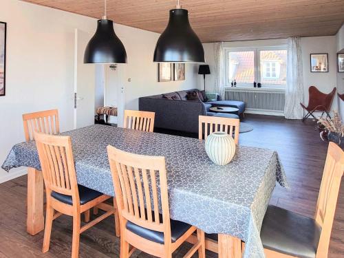 a dining room table and chairs in a living room at 4 star holiday home in Brønderslev in Brønderslev