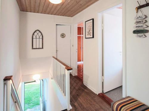 a hallway with white walls and a staircase with a window at 4 star holiday home in Brønderslev in Brønderslev