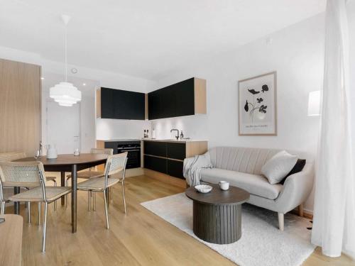 a living room with a couch and a table at 5 star holiday home in Aarhus C in Aarhus