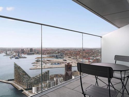 a balcony with a table and a view of the city at 5 star holiday home in Aarhus C in Aarhus