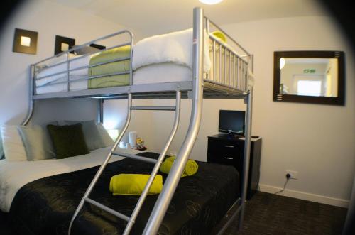 a bedroom with a bunk bed and a bunk bedskirts at Birchfields Guest House in Manchester