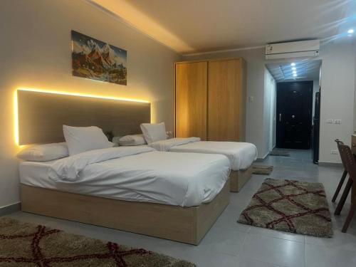 a bedroom with two beds and a large headboard at Scandic resort chalet sea view in Hurghada