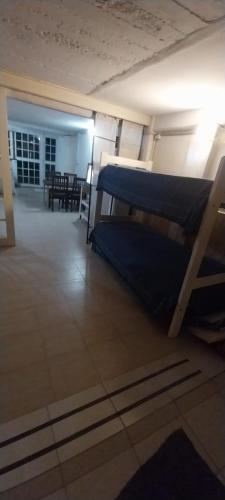 a room with two bunk beds and a living room at BackPakersBasic in Tigre