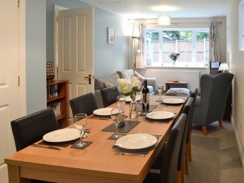 a dining room with a wooden table and chairs at Hideaway Cottage in Kingsgate
