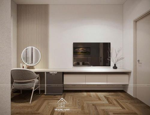a living room with a tv and a chair at Tuỳ Tâm Luxury Hotel Quảng Trị in Ðông Hà