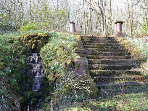 a set of stone stairs next to a waterfall at The Old Stables in Uldale
