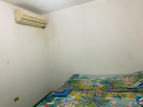 a bedroom with a bed and a air conditioner at African Symbol Guest House in Montego Bay
