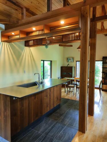 an open kitchen with a sink and a dining room at villa EDEN-Minamiboso- in Minamiboso