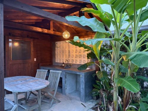 a patio with a table and chairs and a table at villa EDEN-Minamiboso- in Minamiboso