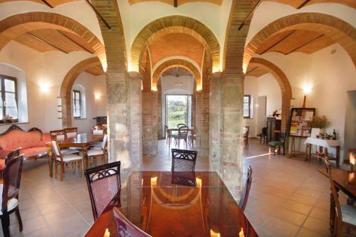 a dining room with a table and chairs in a building at Tenuta Il Tresto in Poggibonsi