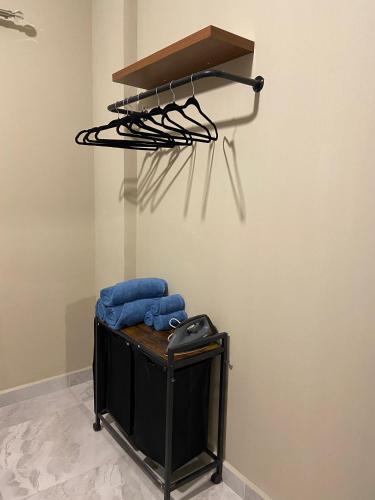 a room with a hanger and some blue towels at Cosy, accessible, comme et sécure in Kinshasa