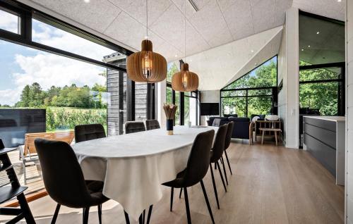 a kitchen and dining room with a table and chairs at Stunning Home In Odder With Sauna in Odder