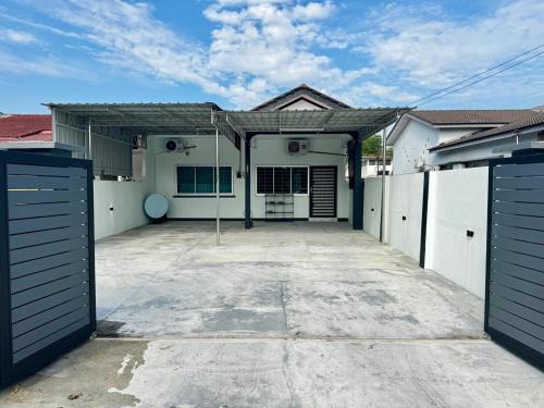 a house with two garage doors and a driveway at i Homes 19 at Ipoh Town 3R2B 9pax in Ipoh