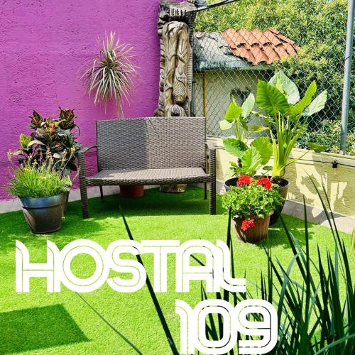 a sign for a garden with a bench and plants at Hostal 109 Roma - Condesa in Mexico City