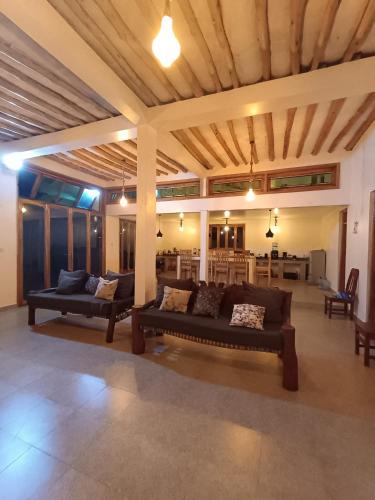 a living room with two couches and a table at Wasini house mkwiro village in Shimoni