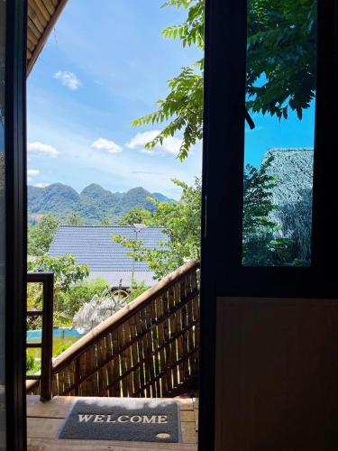 a door to a porch with a view of the mountains at Puluong Mist Valley Home in Pu Luong