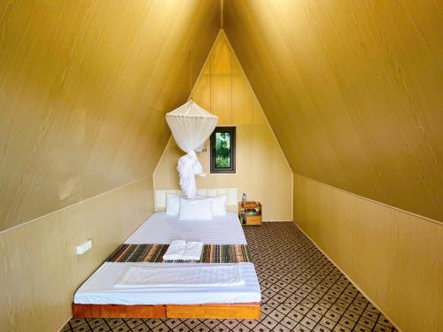 a small room with two beds in a roof at Puluong Mist Valley Home in Pu Luong
