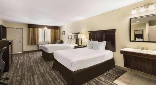 a hotel room with two beds and a sink at Best Western Frontier Motel in Lone Pine