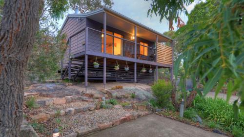 a house on a hill with a tree at 31 The Rocks in Stanthorpe