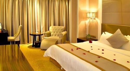 a hotel room with a bed and a chair at Quanzhou Binhai Hotel in Quanzhou