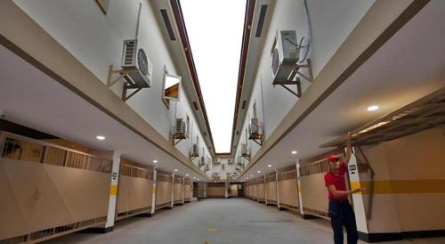 a man standing in a hallway of a building at Horizon Hotel in Olongapo