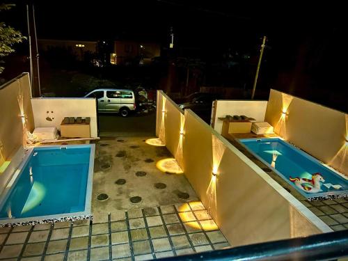 a row of hot tubs on a patio at night at Adonai villa 1 in Albion
