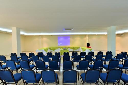a conference room with blue chairs and a table at Gran Hotel De Lago - El Coca in Puerto Francisco de Orellana