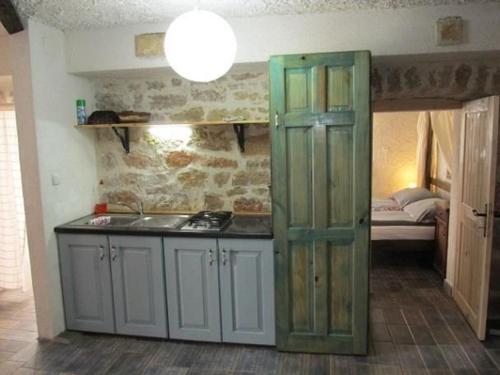 a kitchen with a sink and a room with a bed at Fischer Fritz 2 in Betina
