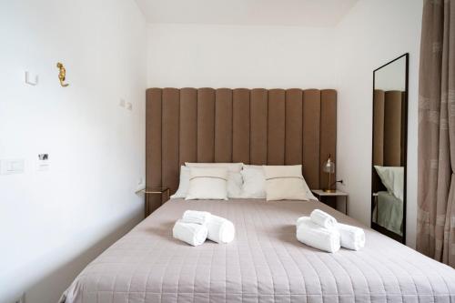 a bedroom with a large bed with two towels on it at Altamarea Rooms - Luxury Seaview Suites in Polignano a Mare