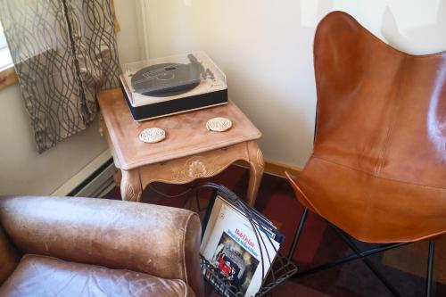 a table with a radio on it next to a chair at Rocky Mountain Inn in Paonia
