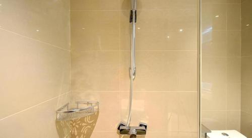 a shower with a glass door in a bathroom at City Comfort Inn Lichuan Railway Station Jimi Home in Enshi