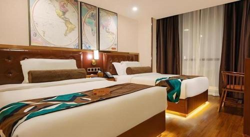 a hotel room with two beds and a map on the wall at James Joyce Coffetel Guilin Railway Station Xiangbi Mountain Liangjiang Sihu Wharf in Guilin