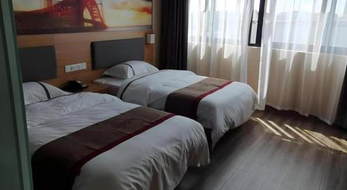 a hotel room with two beds and a window at Thank Inn Hotel Jiangsu Wuxi High-Tech Zone Ruigang Pedestrian Street in Wuxi