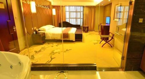a bathroom with a bedroom with a bed and a tub at VX Hotel Chengdu Jiaolong Port Haibin in Chengdu