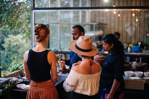 a group of women standing in a kitchen preparing food at Green Peak - Mountain View Hotel & Restaurant in Ella