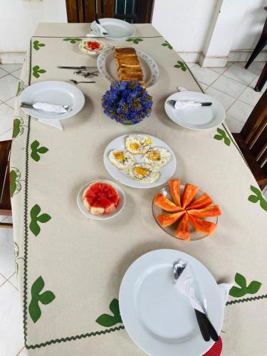 a table with plates of food on it at GB Royal Stay Nuwara Wewa in Nikawatawana