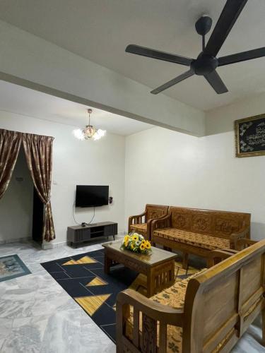 a living room with a couch and a ceiling fan at DM Homestay in Semenyih