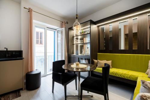 a living room with a yellow couch and a table at Cielo | Suite con Bagno e Cucina Condivisa – Centrale in Polignano a Mare
