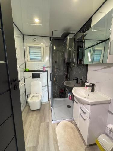 a small bathroom with a toilet and a sink at Sportowa Osada in Strumiany