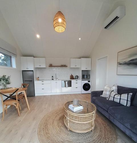 a living room with a couch and a table at Coulson Cottage in Greymouth
