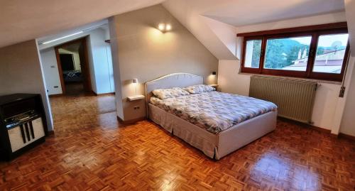 a bedroom with a bed and a large window at Casa Michetti in Castel di Sangro