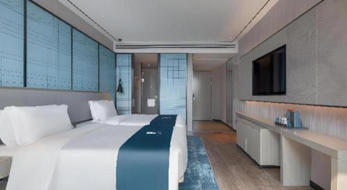 Ένα ή περισσότερα κρεβάτια σε δωμάτιο στο Echarm Hotel Zhuzhou Liling