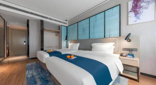 Ένα ή περισσότερα κρεβάτια σε δωμάτιο στο Echarm Hotel Zhuzhou Liling